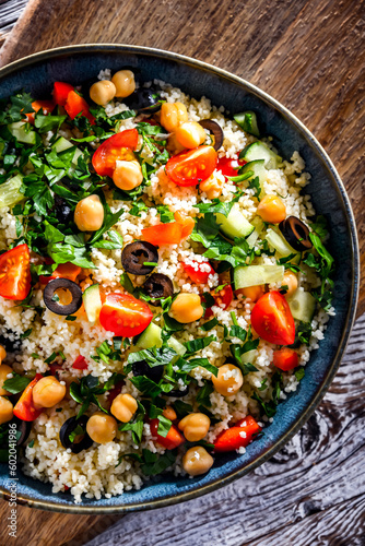 A plate of couscous served with vegetables and chickpeas