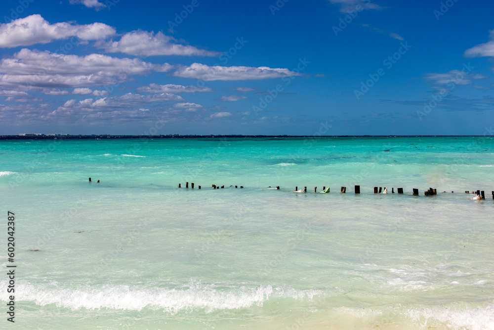 Beautiful white sand beach in the caribbean sea with beautiful turquoise colors under a blue sky. Caribbean beaches of golden sand under a tropical sun in isla mujeres. Paradise beach concept. Beautiful white sand beach in the caribbean sea with beautiful turquoise colors under a blue sky. Caribbean beaches of golden sand under a tropical sun in isla mujeres. Paradise beach concept.