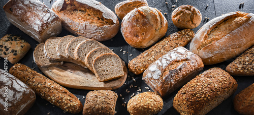 Assorted bakery products including loaves of bread and rolls