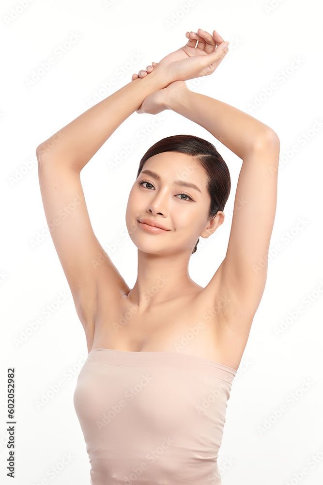 Beautiful Young Asian woman lifting hands up to show off clean and hygienic armpits or underarms on white background, Smooth armpit cleanliness and protection concept