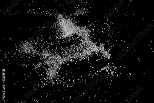 Sea       salt grains  crystals scattered isolated on black background  top view