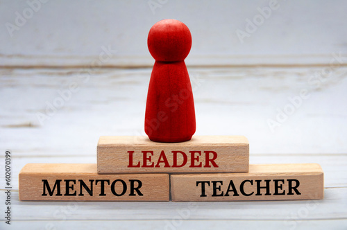 Fotografie Leader, Mentor and Teacher text on wooden blocks with red figure on top