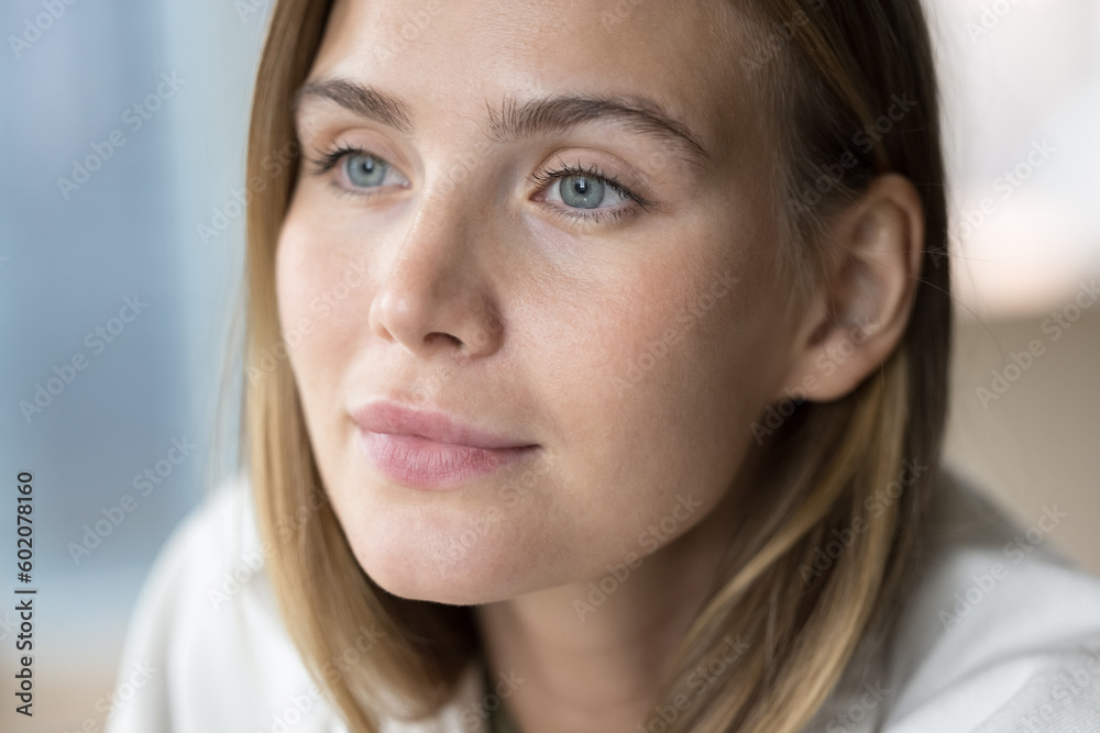 Thoughtful positive beautiful young 20s girl looking away, thinking, dreaming. Beauty care female model face with perfect smooth skin, thick eyelashes, eyebrows, pale blue eyes Thoughtful positive beautiful young 20s girl looking away, thinking, dreaming. Beauty care female model face with perfect smooth skin, thick eyelashes, eyebrows, pale blue eyes