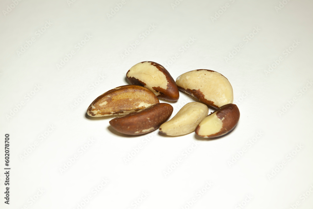Several brazil nuts on a white background.