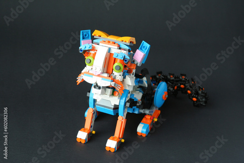 The robot cat sat down on its hind legs