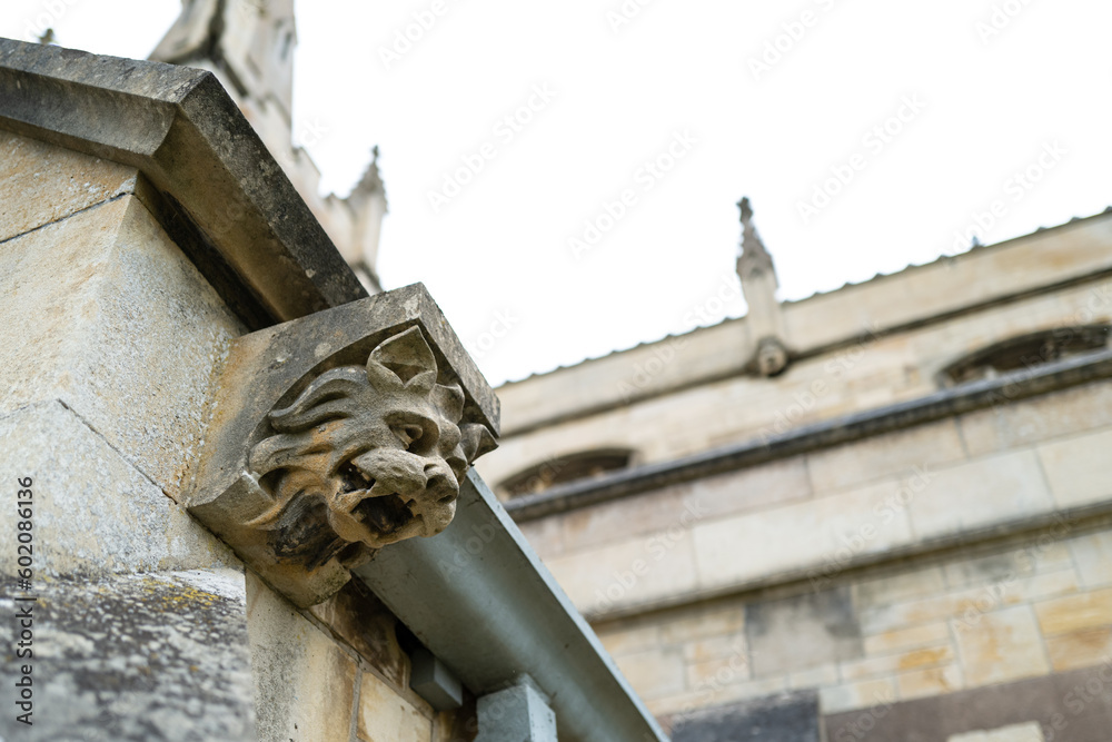 Shallow focus of an ancient gargoyle figure seen at the entrance to an English church. Shallow focus of an ancient gargoyle figure seen at the entrance to an English church.