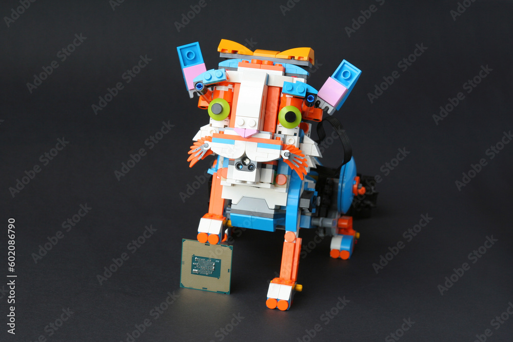 Robot cat holding, front paw, computer processor Robot cat holding, front paw, computer processor
