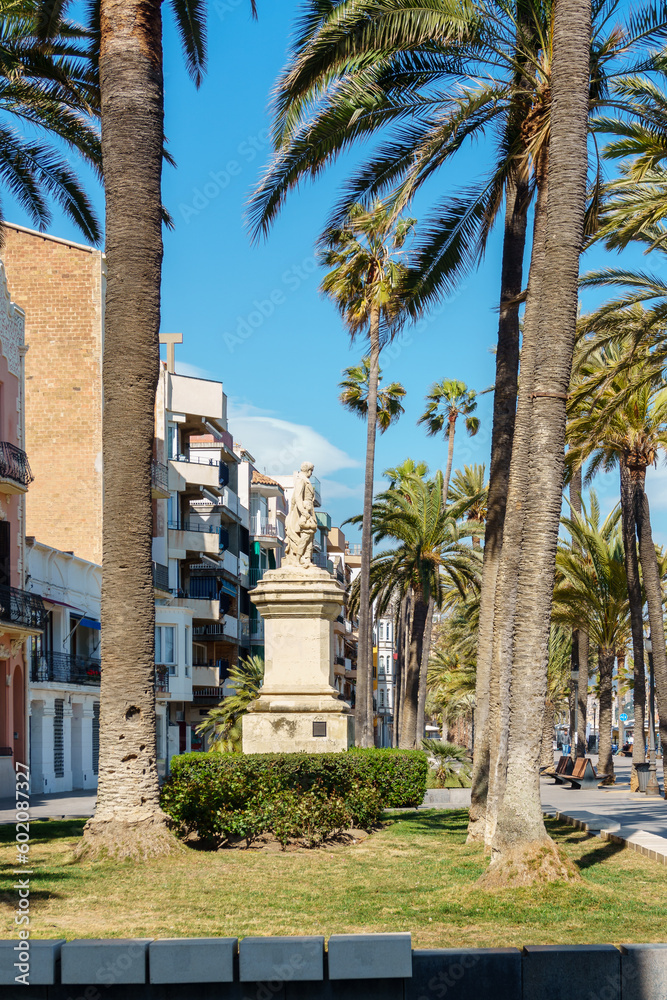 Ramblas , Badalona, Spain with modernist buildings and the statue of Roca i Pí. Seafront promenade