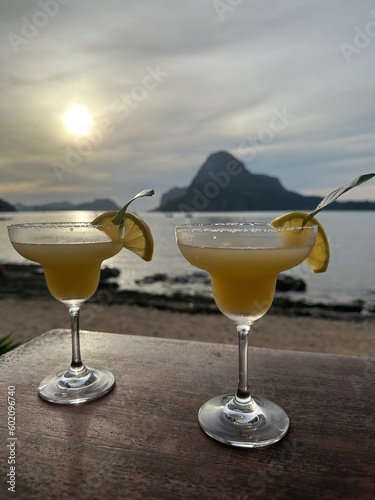 Two lime margarita cocktails on a table at sunset,  El Nido, Palawan, Mimaropa, Luzon, Philippines photo