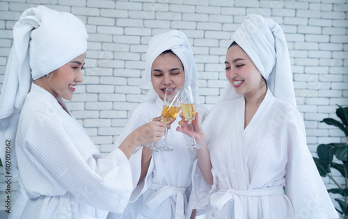 three asian female wear white bathrobe at bed room