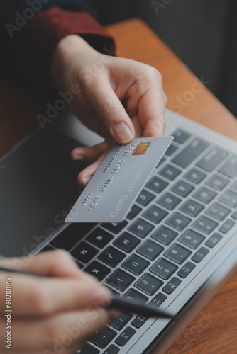 Women holding credit card and using smartphones at home.Online shopping, internet banking, store online, payment, spending money, e-commerce payment at the store, credit card, concept