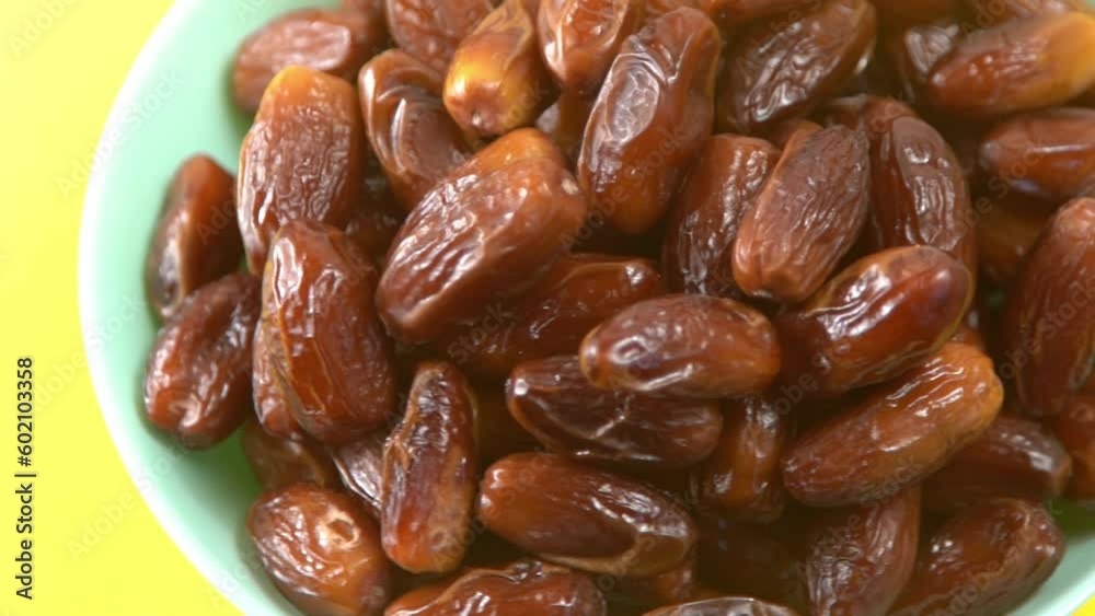 Dates. Dried date palm fruits. Healthy sweet snack food bowl. Pile of tasty dry dattes in plate. Date harvest symbolizing Ramadan. Dates. Dried date palm fruits. Healthy sweet snack food bowl. Pile of tasty dry dattes in plate. Date harvest symbolizing Ramadan.