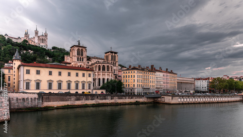 Panoramic view of the "Vieux-Lyon", medieval old town of Lyon, France, and the Fourvière Hill on a cloudy day, with the Rhône river in the foreground.