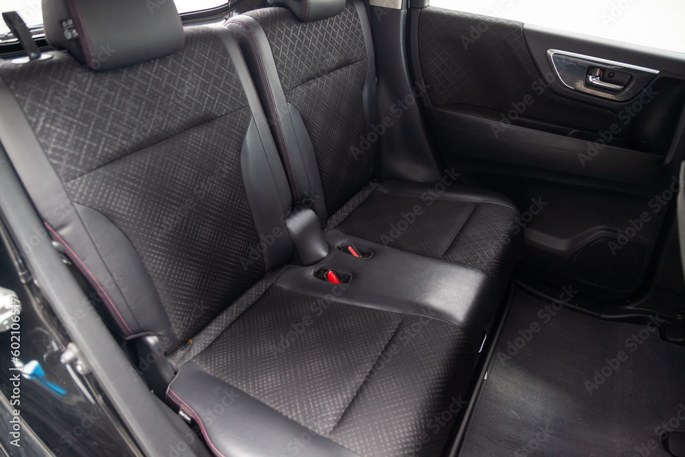 Close-up on rear seats with velours fabric upholstery in the interior of an modern japanese car in gray after dry cleaning. Auto service industry. Close-up on rear seats with velours fabric upholstery in the interior of an modern japanese car in gray after dry cleaning. Auto service industry.