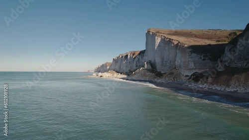 Aerial of impressive Normandy's white cliffs, round pebbles beaches and green pasture on the Alabaster Coast, France, 4K drone photo