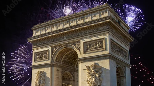 Celebratory fireworks over the Arc de Triomphe ( 4K, time lapse, with zoom), Paris, France. The walls of the arch are engraved with the names of 128 battles and names of 660 French military leaders  photo