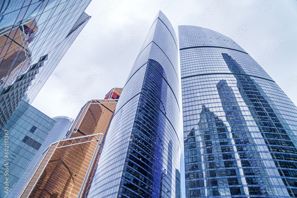 Fototapeta premium Modern shining skyscrapers of glass and metal with reflections.