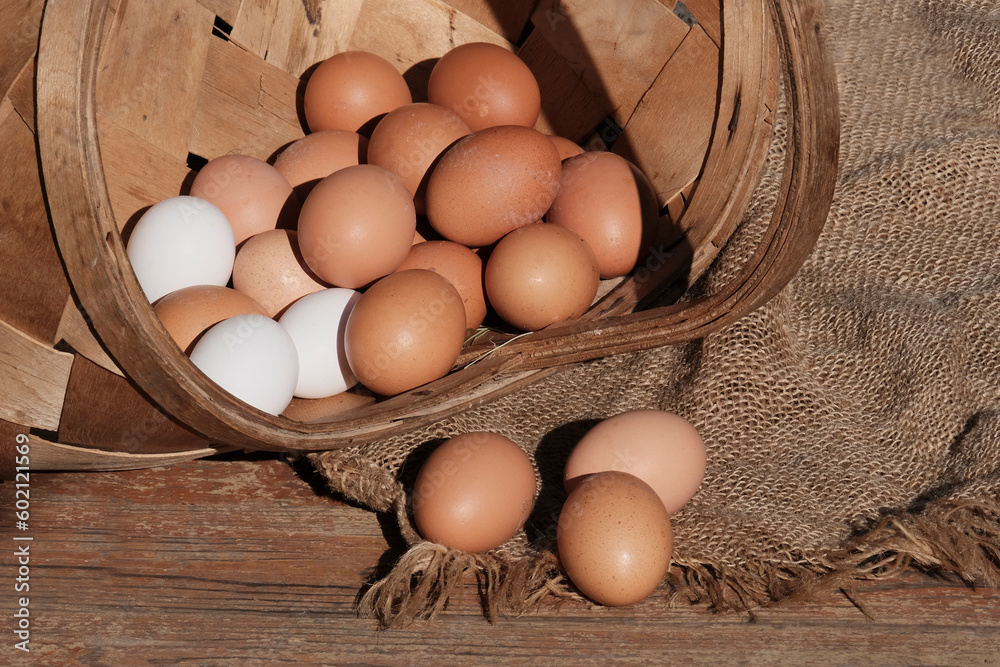 Beautiful brown colored eggs in a wooden basket in sunlight. Farmer's market, Egg price, increase. dietary product. Beautiful background with eggs. Beautiful brown colored eggs in a wooden basket in sunlight. Farmer's market, Egg price, increase. dietary product. Beautiful background with eggs.