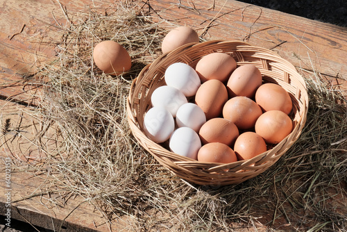 Beautiful brown colored eggs in a wooden basket in sunlight. Farmer's market, Egg price, increase. dietary product. Beautiful background with eggs.