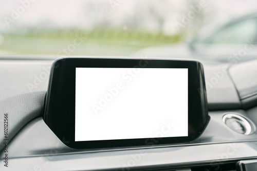 Modern car infotainment head unit system with phone, music, and navigation mockup. Close up of blank screen in car interior. photo