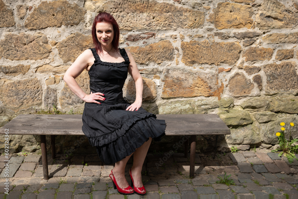 mature lady over 40 sits on a bench mature lady over 40 sits on a bench