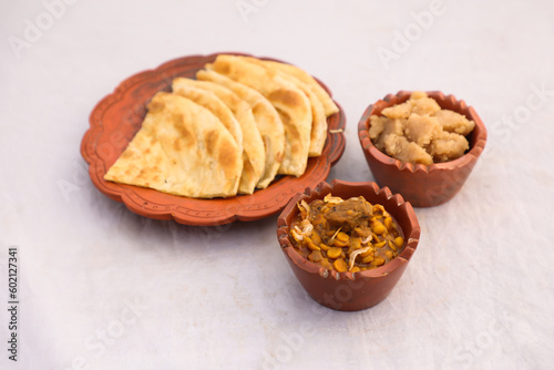 Desi nashta dal chicken, halwa and paratha served in dish isolated on background top view of bangladesi breakfast