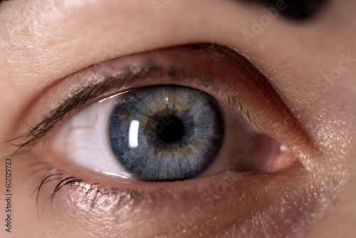 Fototapeta Naklejka Na Ścianę i Meble -  Blue female eye close up. The pupil and cornea of the female eye