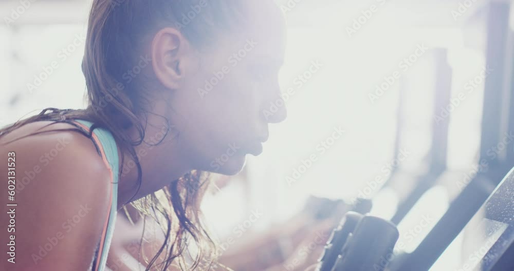 Tired, cycling and face of woman at gym for fitness workout, weight loss or endurance training. Breathing, sweat and fatigue with real girl in spin class for sports, health and cardio challenge