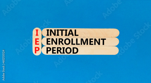 IEP symbol. Concept words IEP Initial enrollment period on beautiful wooden sticks. Beautiful blue table blue background. Medical and IEP Initial enrollment period concept. Copy space.