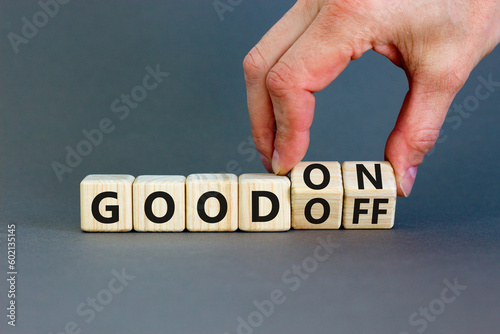 Good on or off symbol. Businessman turns wooden cubes and changes word Good off to Good on. Beautiful grey table grey background. Business and good on or off concept. Copy space.