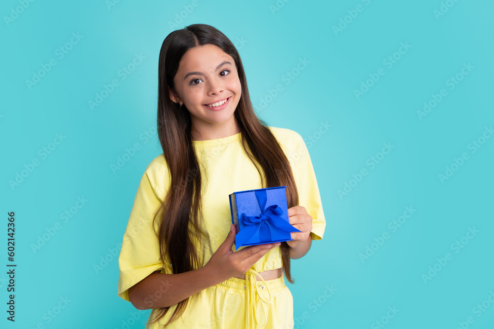 Emotional teenager child hold gift on birthday. Funny kid girl holding gift boxes celebrating happy New Year or Christmas. Happy girl face, positive and smiling emotions. Emotional teenager child hold gift on birthday. Funny kid girl holding gift boxes celebrating happy New Year or Christmas. Happy girl face, positive and smiling emotions.