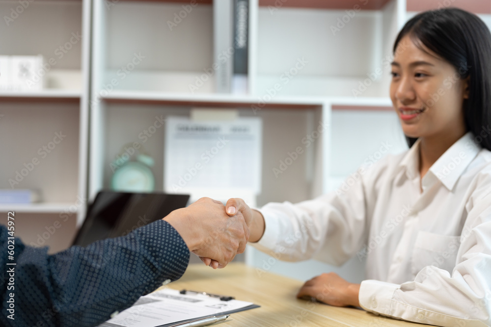 businessman shaking hands congratulating young woman who applied businessman shaking hands congratulating young woman who applied