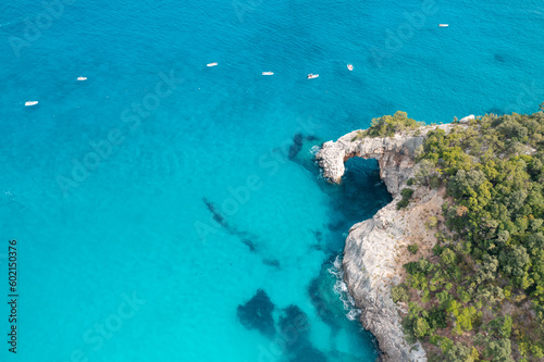 Top drone view Cala Goloritze, Sardinia, Italy. Aerial view of seascape with sea lagoon, transparent water and rocks on a sunny day, summer background © kucherav