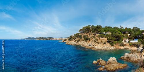 Summer sea rocky coast view (near Lloret de Mar town, Catalonia, Spain). People unrecognizable.