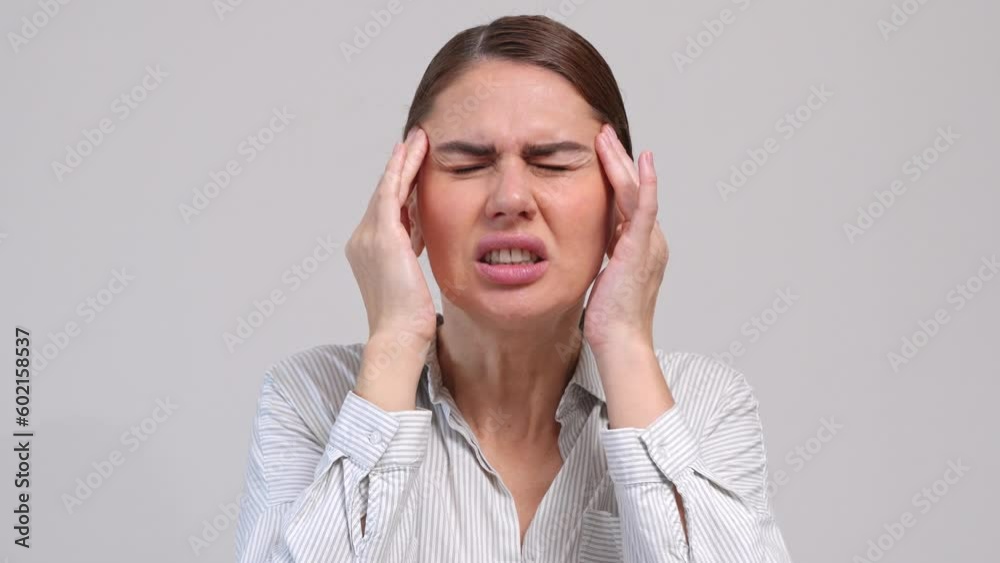 Middle-aged woman suffer from headache over grey background. Middle-aged woman suffer from headache over grey background.