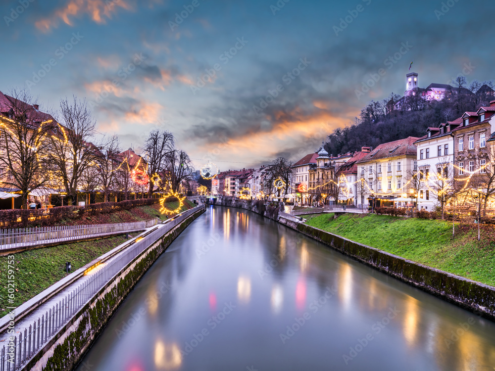 long exposure shot of Ljubljana river and riverside streets lit up with  and Christmas lights, Slovenia