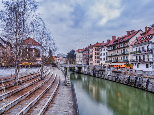 Ljubljana river and riverside buildings at Ivan Hribar on a cloudy afternoon, Slovenia