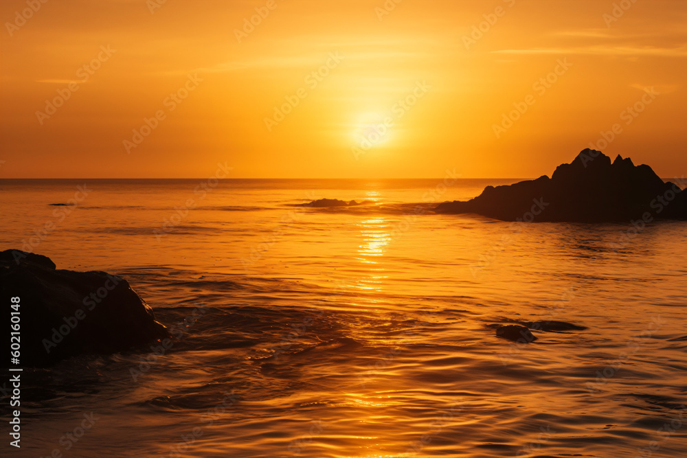 The sun is setting over the ocean with rocks in the water Generative Ai The sun is setting over the ocean with rocks in the water Generative Ai