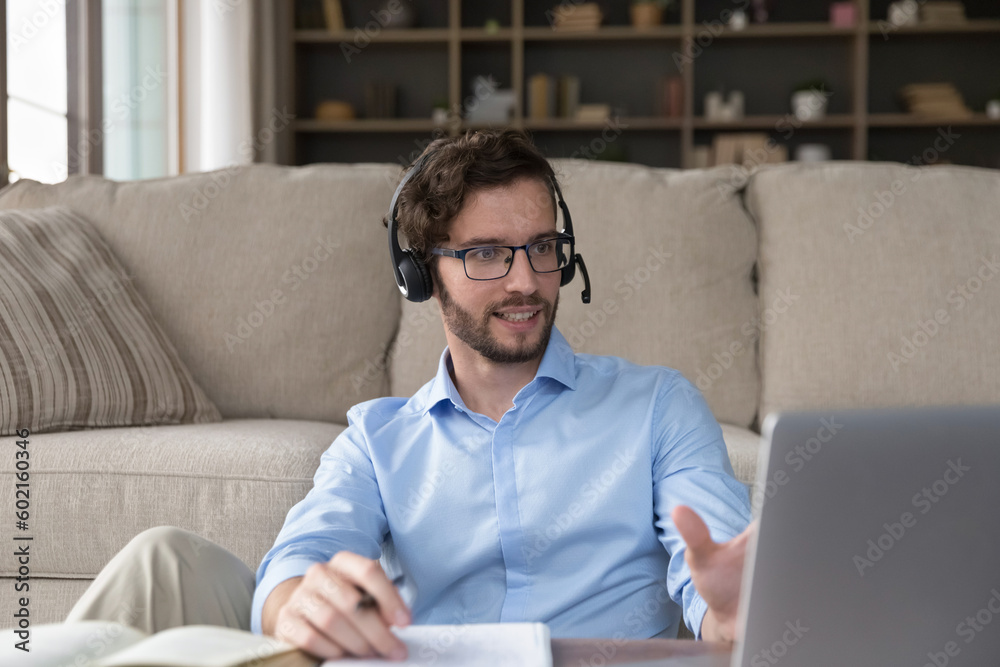 Successful handsome young adult student man in headphones attending online educating seminar, class, lesson, using laptop for Internet conference connection, learning video call Successful handsome young adult student man in headphones attending online educating seminar, class, lesson, using laptop for Internet conference connection, learning video call