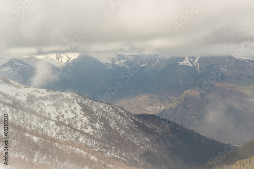 Ascent to Pastukhova Mountain on Arkhyz. Snow-capped mountains with low clouds © lindely