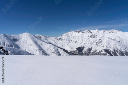 low angle photo of fresh snow covered alpine mountains landscape in winter with copy space. Aquila di Giaveno, Italian Alps. view from the valley to ridges and peaks © Andrea