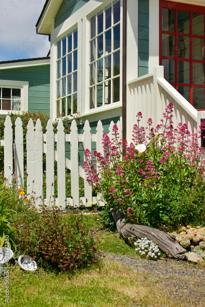 Fototapeta premium charming cottage by the sea with vintage picket fence