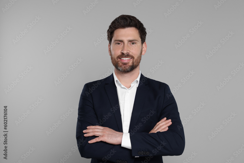 Happy real estate agent on grey background Happy real estate agent on grey background