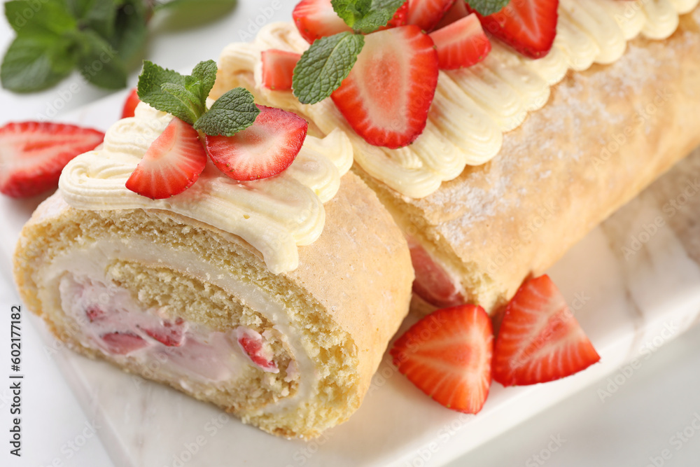 Delicious cake roll with strawberries and cream on white table, closeup