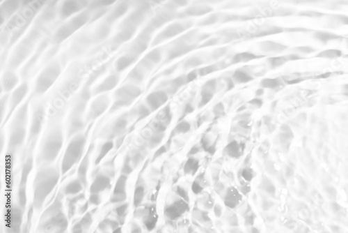Rippled water on white background, top view