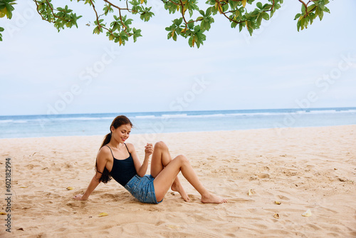 sitting woman smile relax beach vacation sand sea freedom travel nature