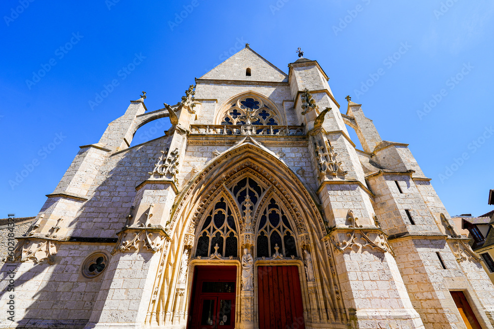 Facade of Our Lady of the Nativity gothic church with flying buttresses in the medieval town of Moret-sur-Loing in Seine et Marne, France