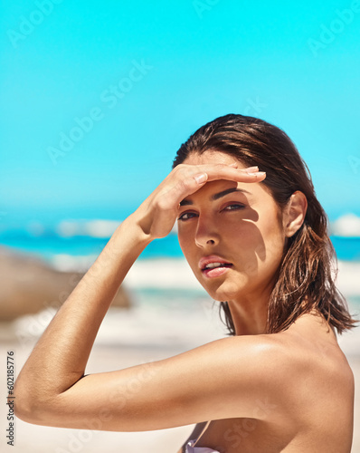 Portrait, beach and woman with sunshine, travel and summer holiday on a break, relax and beauty. Face, female traveler and tourist on a vacation, sunlight and ocean view on a tropical island trip