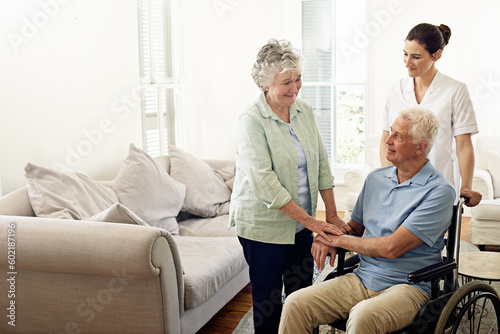 Volunteer, help and old couple with wheelchair, caregiver at nursing home for person with a disability and rehabilitation. Healthcare, clinic and senior patient with nurse together retirement service