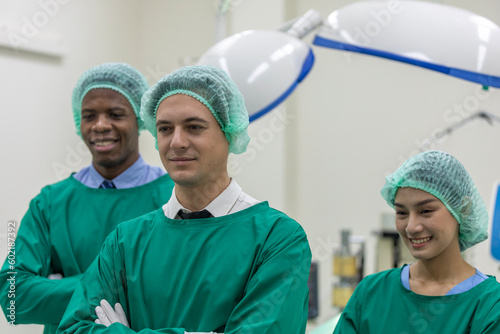 Team of medical doctors or surgeons from different nationalities stand with confident to provide health care service to patient in a surgery room